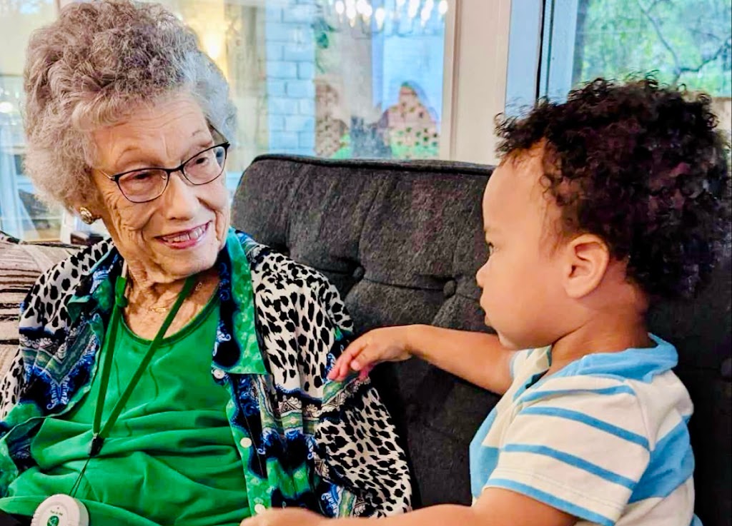 an older woman and child sitting on a couch