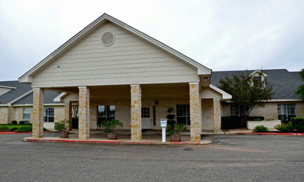 the front of a building with a sign in front