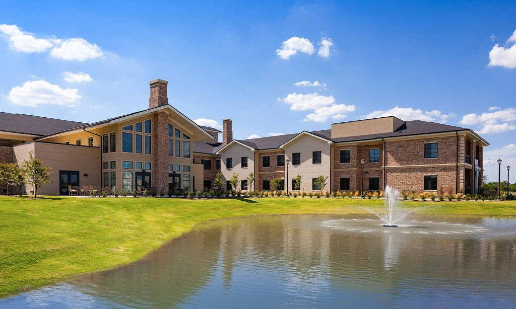 a large house with a pond in front