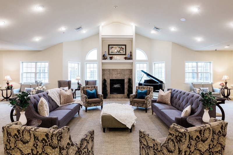 the living room has a large fireplace and a large couch