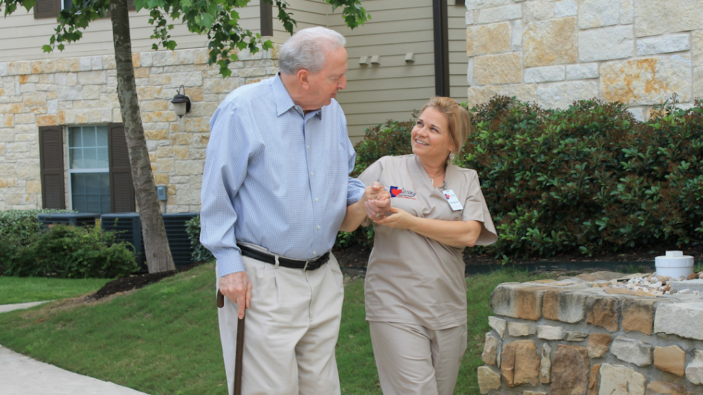 a man and woman standing outside of a house