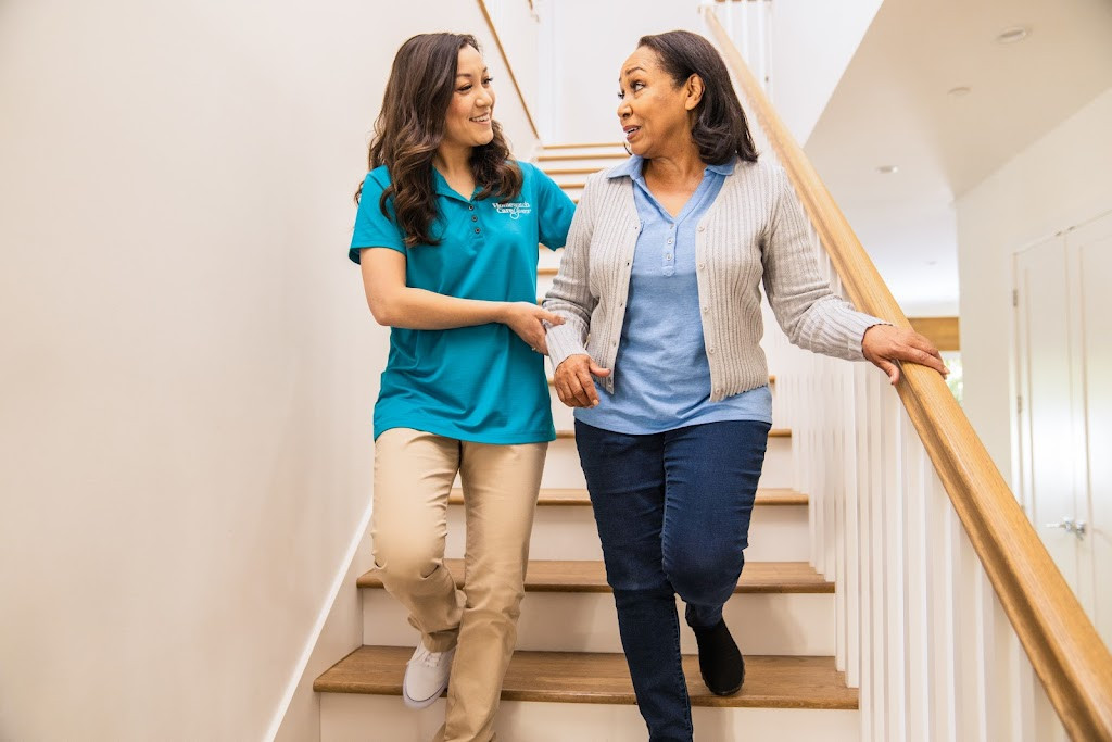 two women walking up the stairs in their home