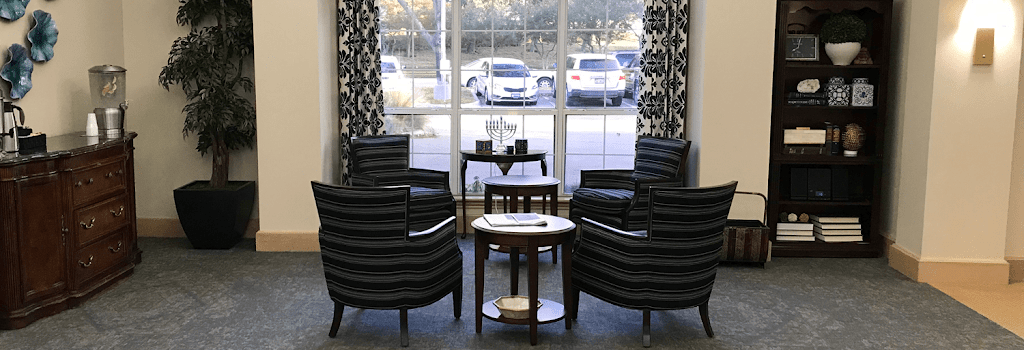 a room with a table and chairs and a window