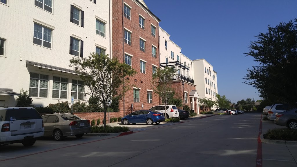 a street with cars parked in front of a building