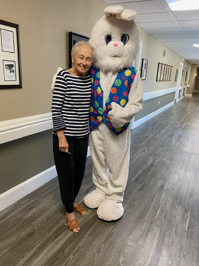 a woman standing next to a white rabbit