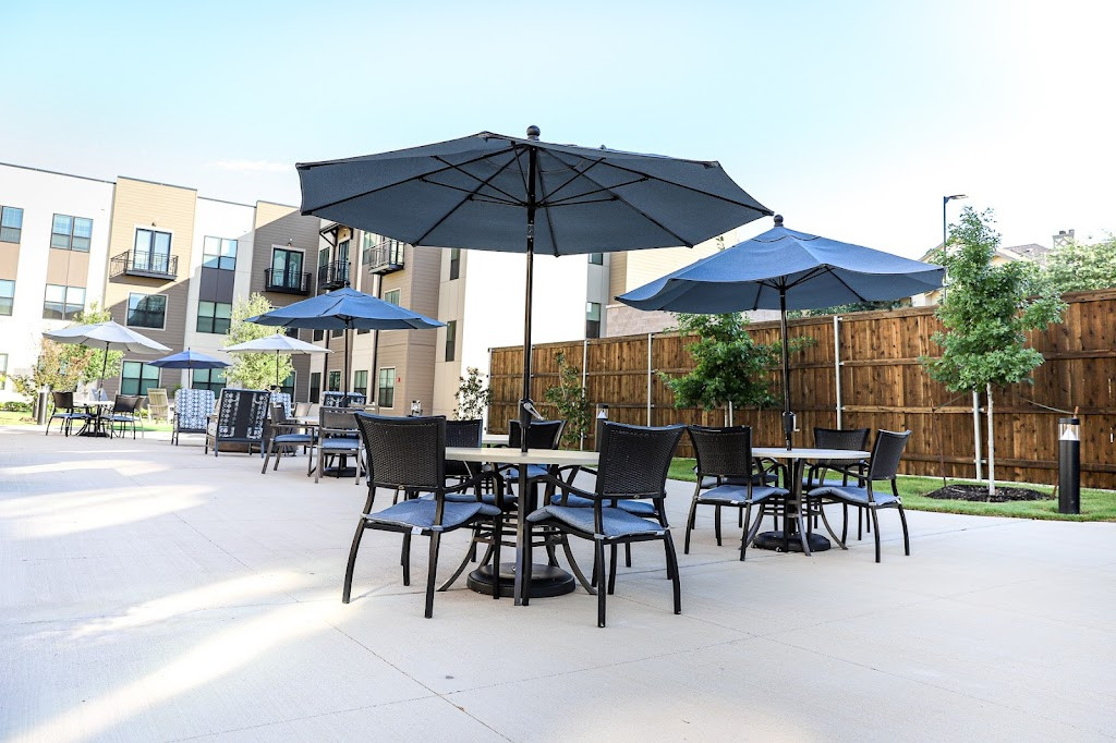a patio with tables and umbrellas