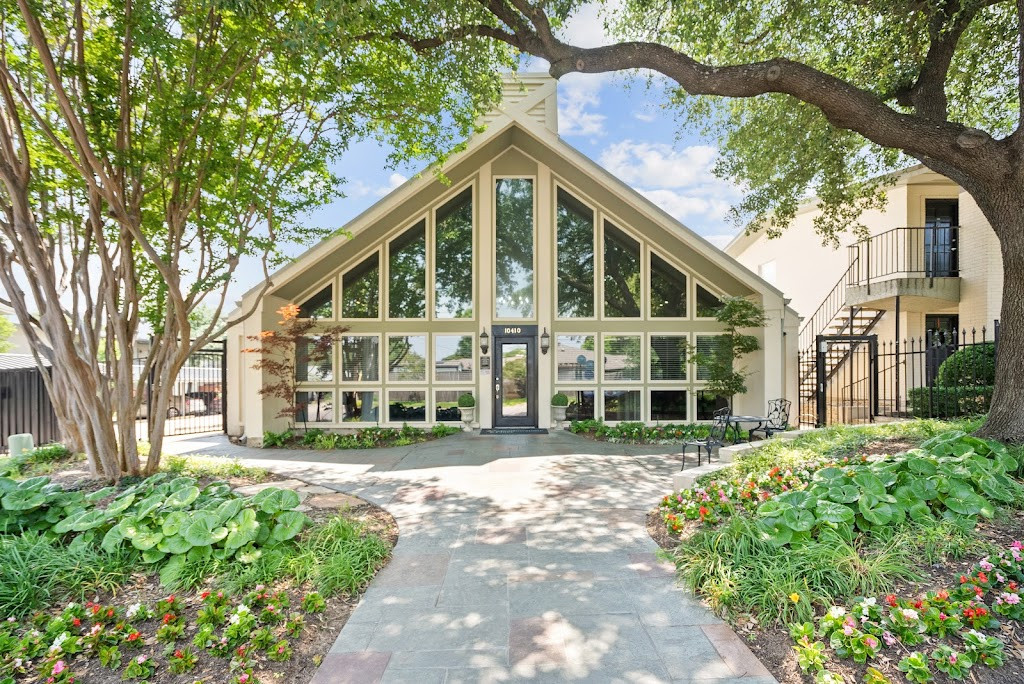 a large house with a walkway leading to the front door