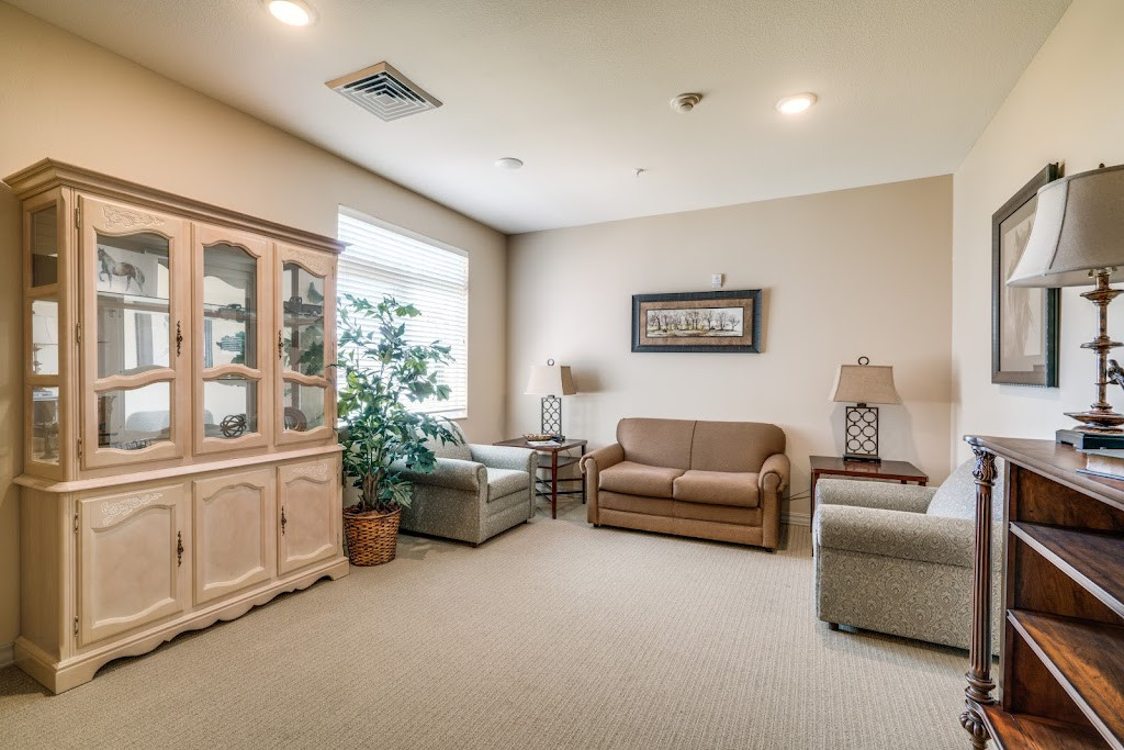 a living room with a couch, chair and television