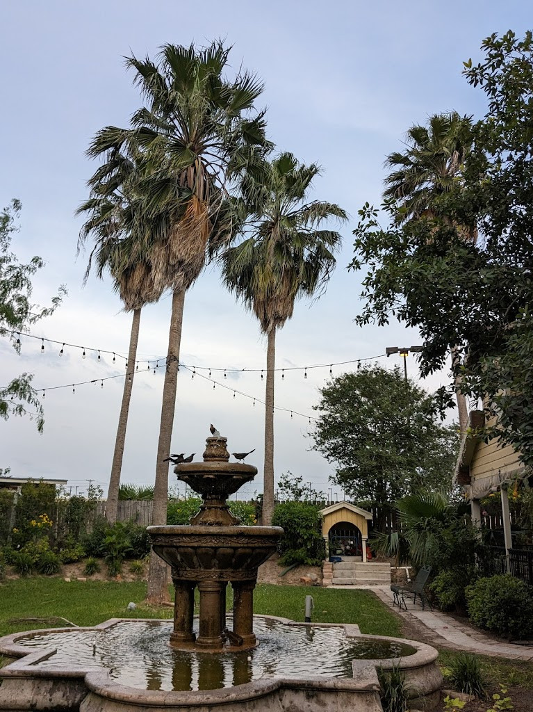 a fountain with palm trees in the background