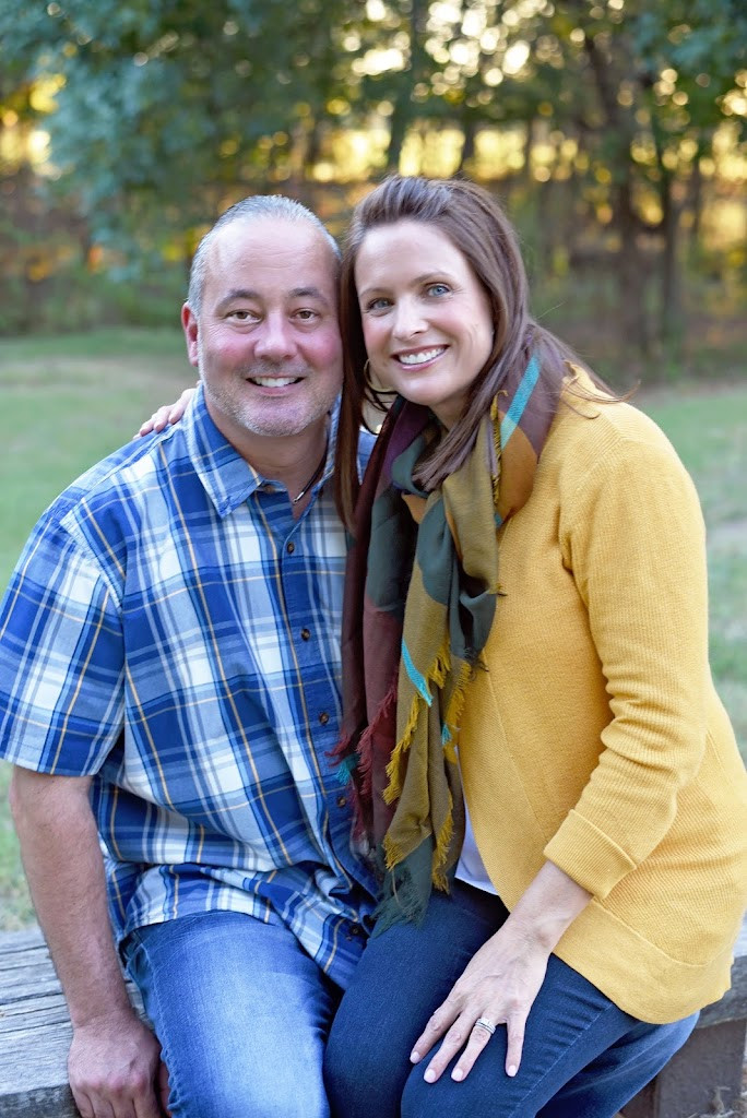 a couple sitting on a bench in the park
