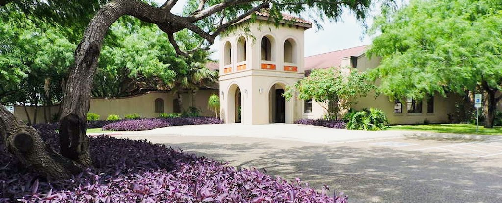a large building with a tree in front of it