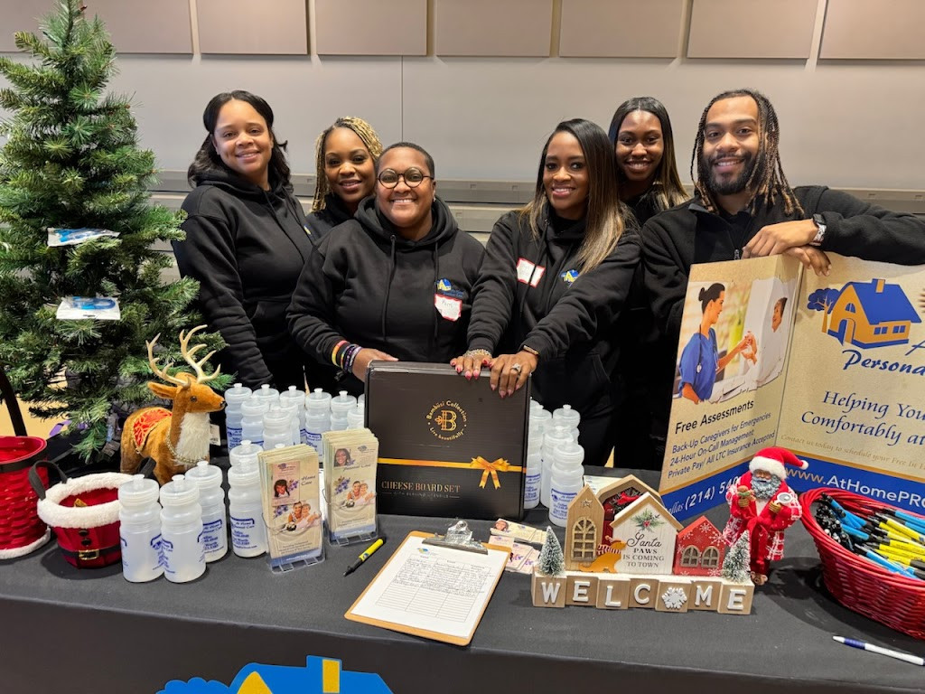 three women standing behind a table with a sign that says, ' we are hiring for the holidays
