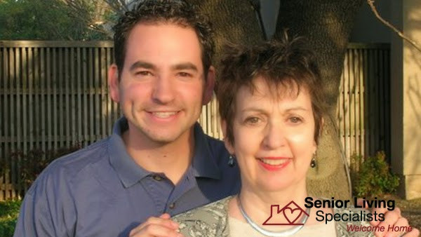a man and woman standing in front of a house