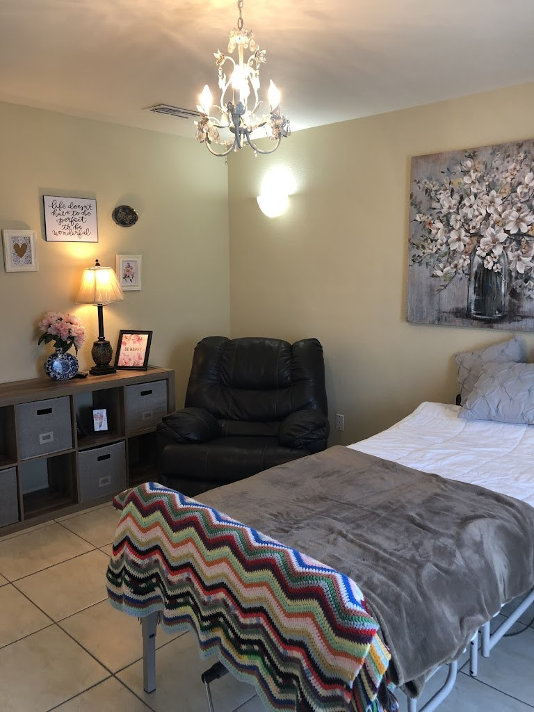 a bed with a blanket and a chair