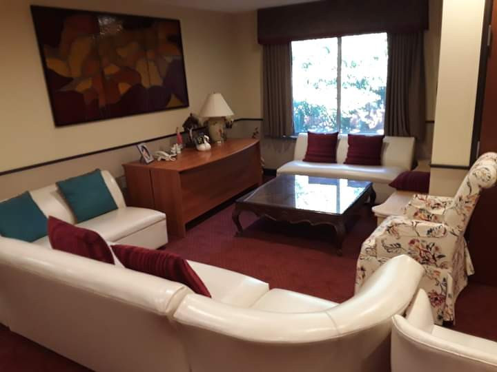 a living room with a couch, coffee table, and a tv